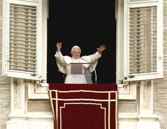 Pope Benedict XVI blesses faithful from the window of his studio overlooking St. Peter's Square at the Vatican on Sunday. More than 100,000 supporters filled the square.